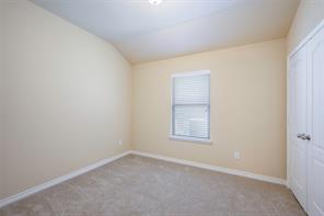 Unfurnished room with carpet flooring and lofted ceiling