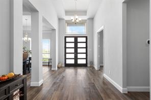 Dining area featuring crown molding, wood-style floors, decorative lighting with plenty of natural light