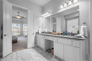 Primary bathroom has frameless shower and soaker tub