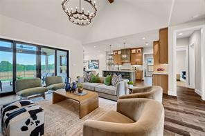 Living room featuring lofted ceiling, hardwood / wood-style floors, and sink