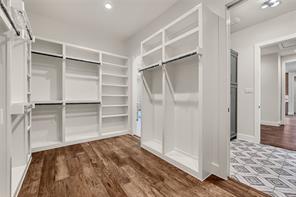 Laundry with built in storage, sink, quartz counters, tile floors