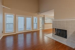 Kitchen with light tile patterned floors, light stone counters, white cabinetry, and sink