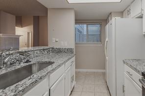 Full bathroom featuring tile patterned flooring, toilet, tiled shower / bath combo, and vanity