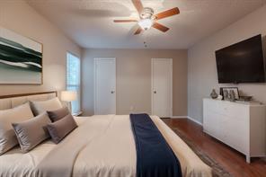 Spare room with a textured ceiling, dark wood-type flooring, and ceiling fan