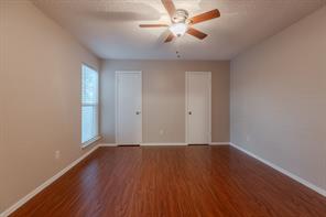 Spare room with a textured ceiling, ceiling fan, and wood-type flooring