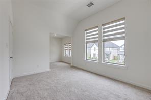 Full bathroom with tile patterned flooring, vanity, toilet, and tiled shower / bath combo