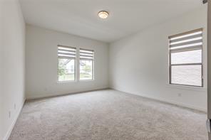 Unfurnished bedroom featuring light colored carpet and ensuite bathroom