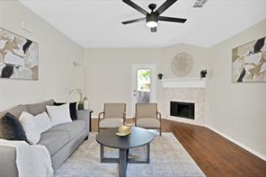 Living room featuring wood-type flooring and ceiling fan