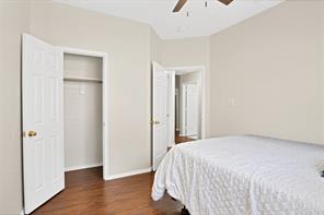 Spare room with lofted ceiling, ceiling fan, and hardwood / wood-style flooring