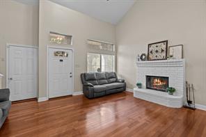 Living room with a towering ceiling, hardwood / wood-style flooring, and crown molding