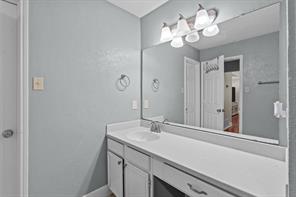 Full bathroom with vanity, a textured ceiling, shower / bath combo, tile patterned flooring, and toilet