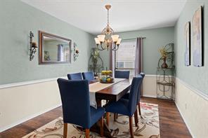 Dining room featuring dark hardwood / wood-style flooring and a notable chandelier