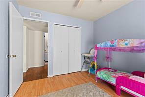 Bedroom featuring ceiling fan and wood-type flooring