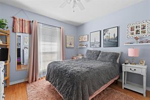 Bedroom with light hardwood / wood-style floors and ceiling fan