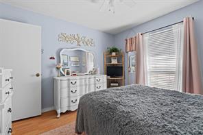 Bedroom featuring ceiling fan, hardwood / wood-style flooring, and ornamental molding