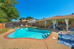 View of swimming pool with a patio and a yard