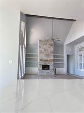 Kitchen with light wood-type flooring, a kitchen island with sink, white cabinetry, and decorative backsplash