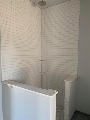 Bathroom featuring a bath and tile patterned flooring