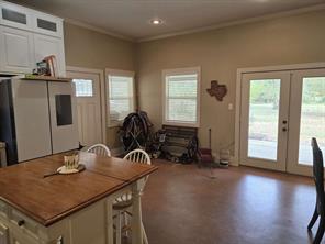 Dining room with ornamental molding, concrete flooring, and ceiling fan