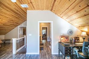 Living area with wood ceiling, vaulted ceiling, ceiling fan, french doors, and dark hardwood / wood-style floors