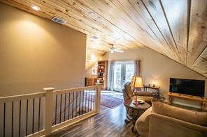 Bathroom with wood ceiling, vaulted ceiling, hardwood / wood-style floors, and shower / tub combo with curtain