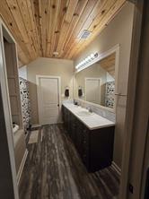 Bathroom featuring a shower with curtain, vanity, and hardwood / wood-style flooring