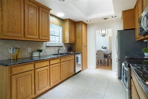 Tiled dining room with ceiling fan and a wealth of natural light