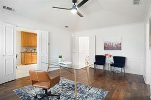 Sitting room with ornamental molding, vaulted ceiling, and dark hardwood / wood-style flooring