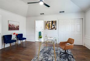 Bedroom featuring ceiling fan, dark wood-type flooring, and multiple windows