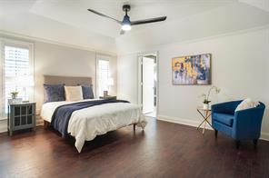 Bedroom featuring crown molding, lofted ceiling, dark hardwood / wood-style floors, and ceiling fan