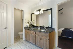 Bathroom featuring tile patterned floors, independent shower and bath, vanity, and crown molding