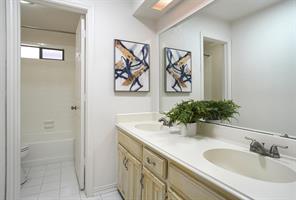 Washroom featuring washing machine and clothes dryer and cabinets