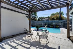 View of swimming pool featuring a patio and an in ground hot tub