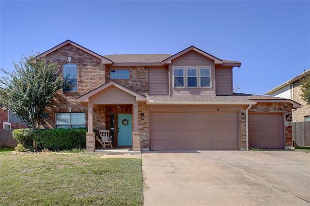 View of front of home featuring a garage and a front lawn