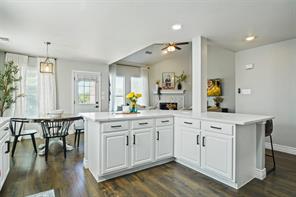 Dining room with dark hardwood / wood-style flooring