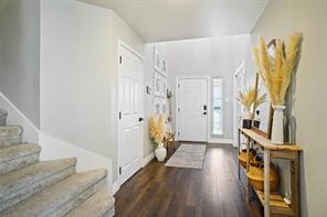 Office area with ceiling fan and dark hardwood / wood-style floors