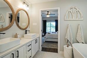 Carpeted bedroom with ceiling fan