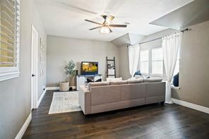 Living room featuring ceiling fan, lofted ceiling, french doors, and hardwood / wood-style floors