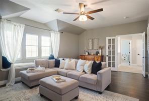 Living room featuring wood-type flooring and ceiling fan